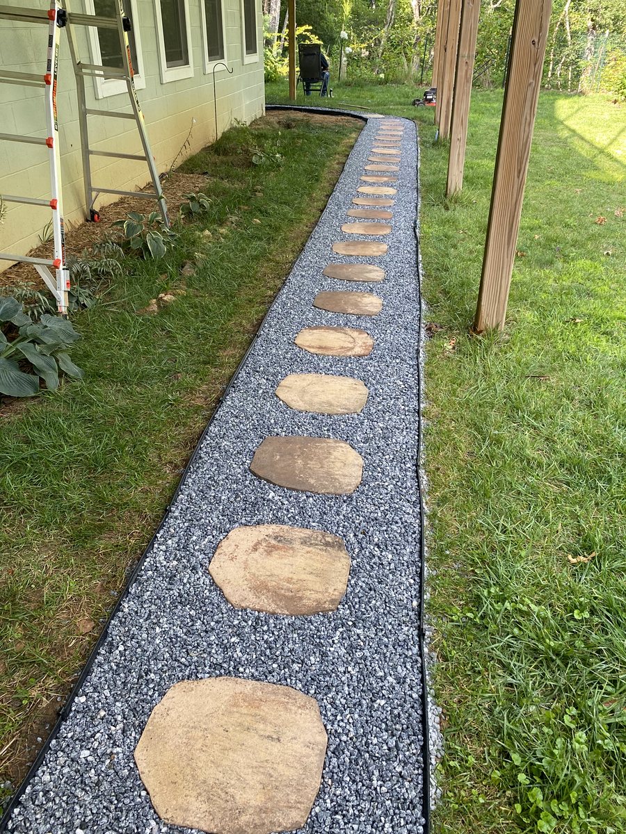 Stepping-stone path through a green mountain lawn built by Nutz Lawncare in Western North Carolina